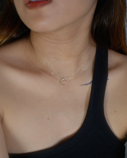 The Tilted Ribbon Heart Necklace in Solid Gold