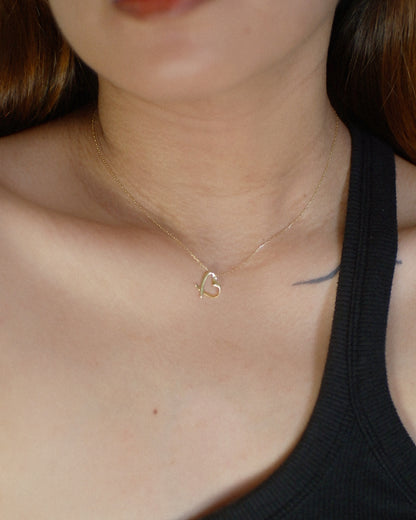 The Tilted Ribbon Heart Necklace in Solid Gold
