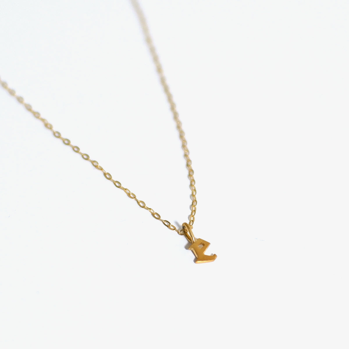 The Tiny Initial Pendant in Solid Gold